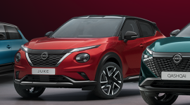 Red Nissan Juke center stage with a blue compact and a teal Qashqai beside it in a showroom lineup.